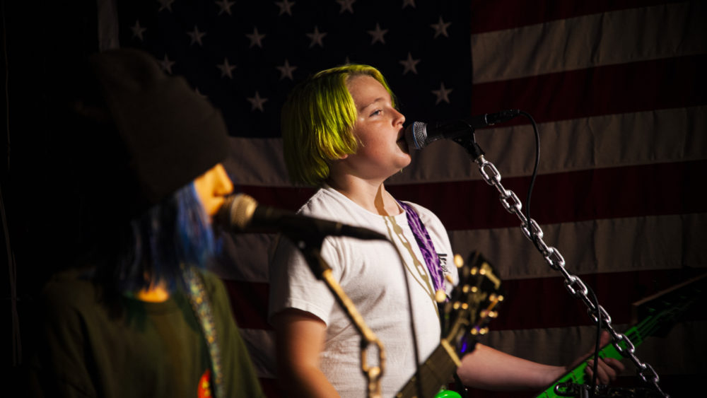 13-year-old Nate Dalbec plays bass guitar for Color Killer. (OJ Slaughter for WBUR)