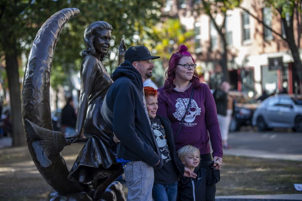 Visitors pose for photographs with the sculpture of Samantha from "Bewitched." (Jesse Costa/WBUR)
