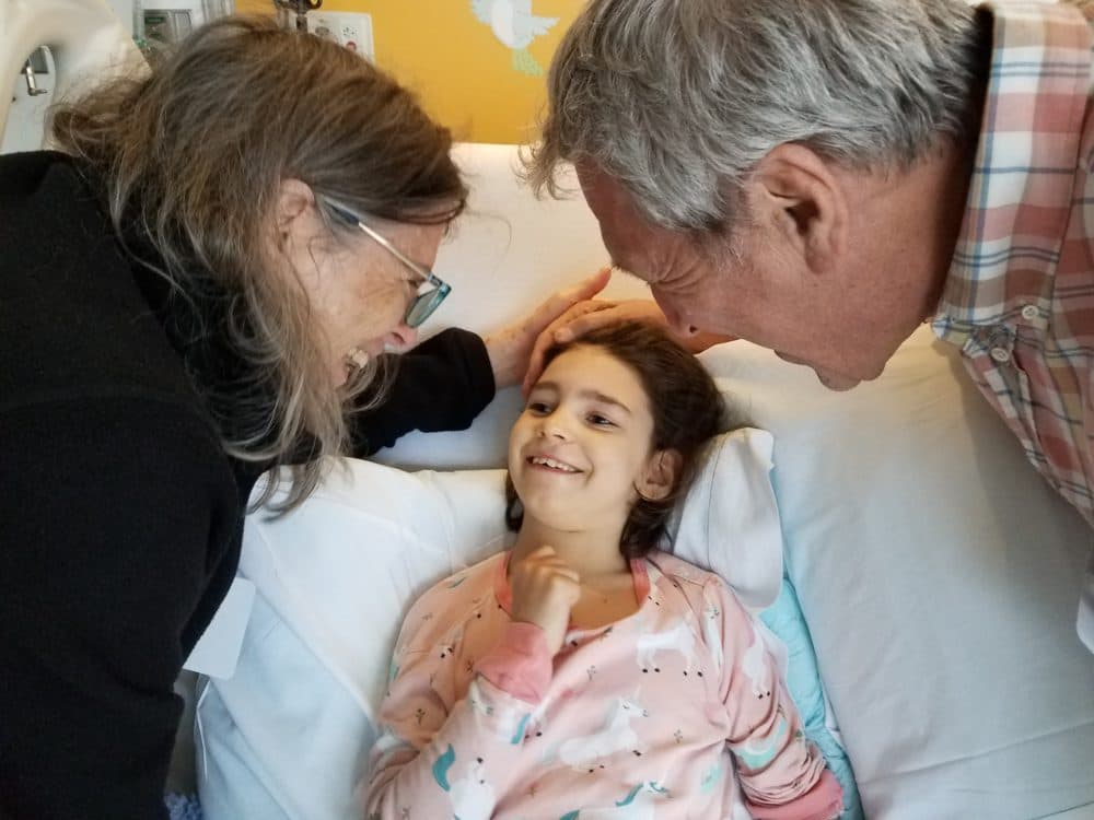 Mila Makovec with her grandparents in the hospital after receiving a dose of milasen in 2019 (Courtesy Julia Vitarello)
