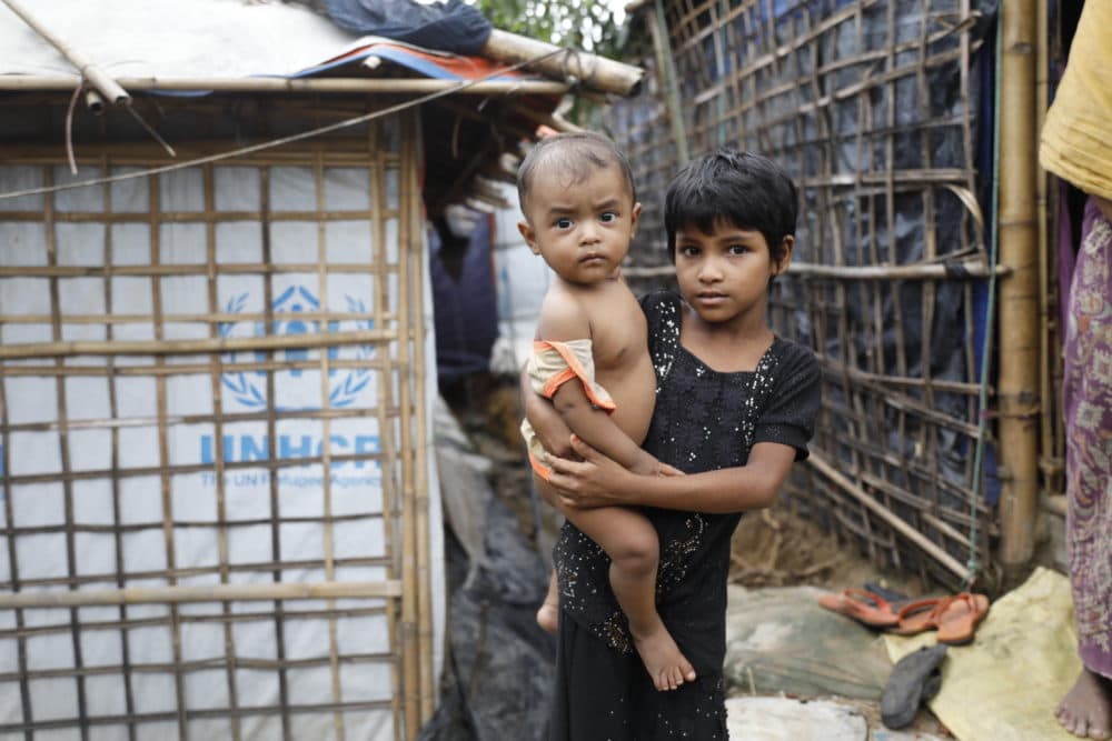 A Rohingya refugee girl holds a child at the Kutupalong refugee camp in Cox's Bazar district, Bangladesh, Monday, June 2, 2018. (AP)