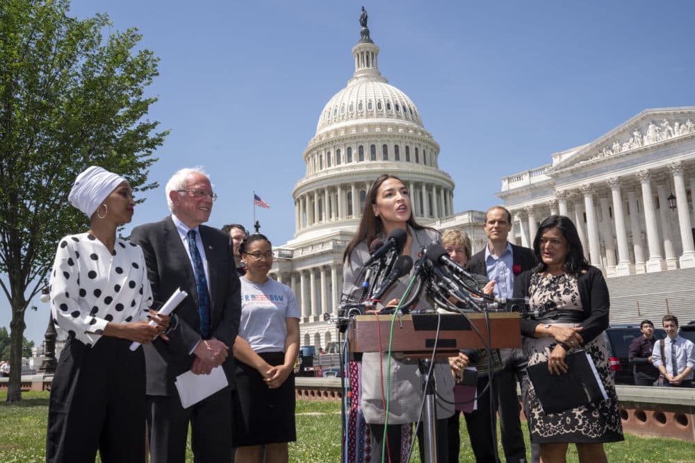 Reps. Ilhan Omar, D-Minn., left, and Alexandria Ocasio-Cortez, D-N.Y., center, have endorsed Sen. Bernie Sanders, who's also shown here, for president. (J. Scott Applewhite/AP)