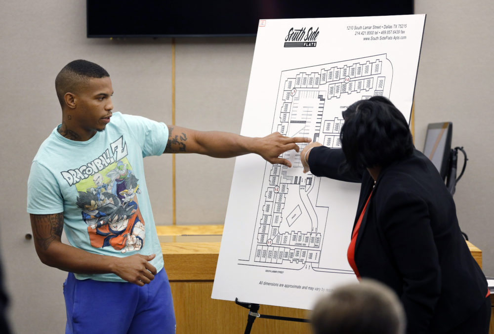 Botham Jean's neighbor Joshua Brown, left, answers questions from Assistant District Attorney LaQuita Long, right, while testifying during the murder trial of former Dallas Police Officer Amber Guyger, in Dallas. Authorities say that Brown was killed in a shooting Friday, Oct. 4. (Tom Fox/The Dallas Morning News via AP Pool)
