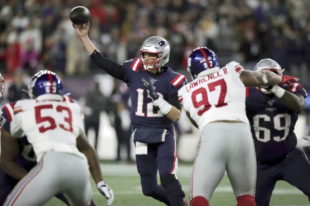 New England Patriots quarterback Tom Brady throws a pass against the New York Giants during the first half of the game. (Charles Krupa/AP)