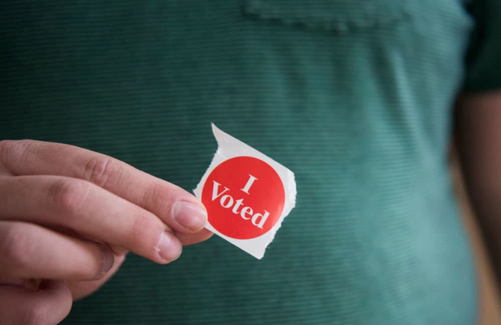 A voter in Minnesota holds their "I Voted" sticker. (Stephen Maturen/Getty Images)