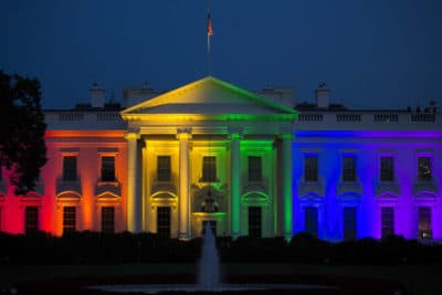 The White House stands illuminated in rainbow-colored light at dusk in Washington, D.C. (Drew Angerer/Bloomberg via Getty Images)