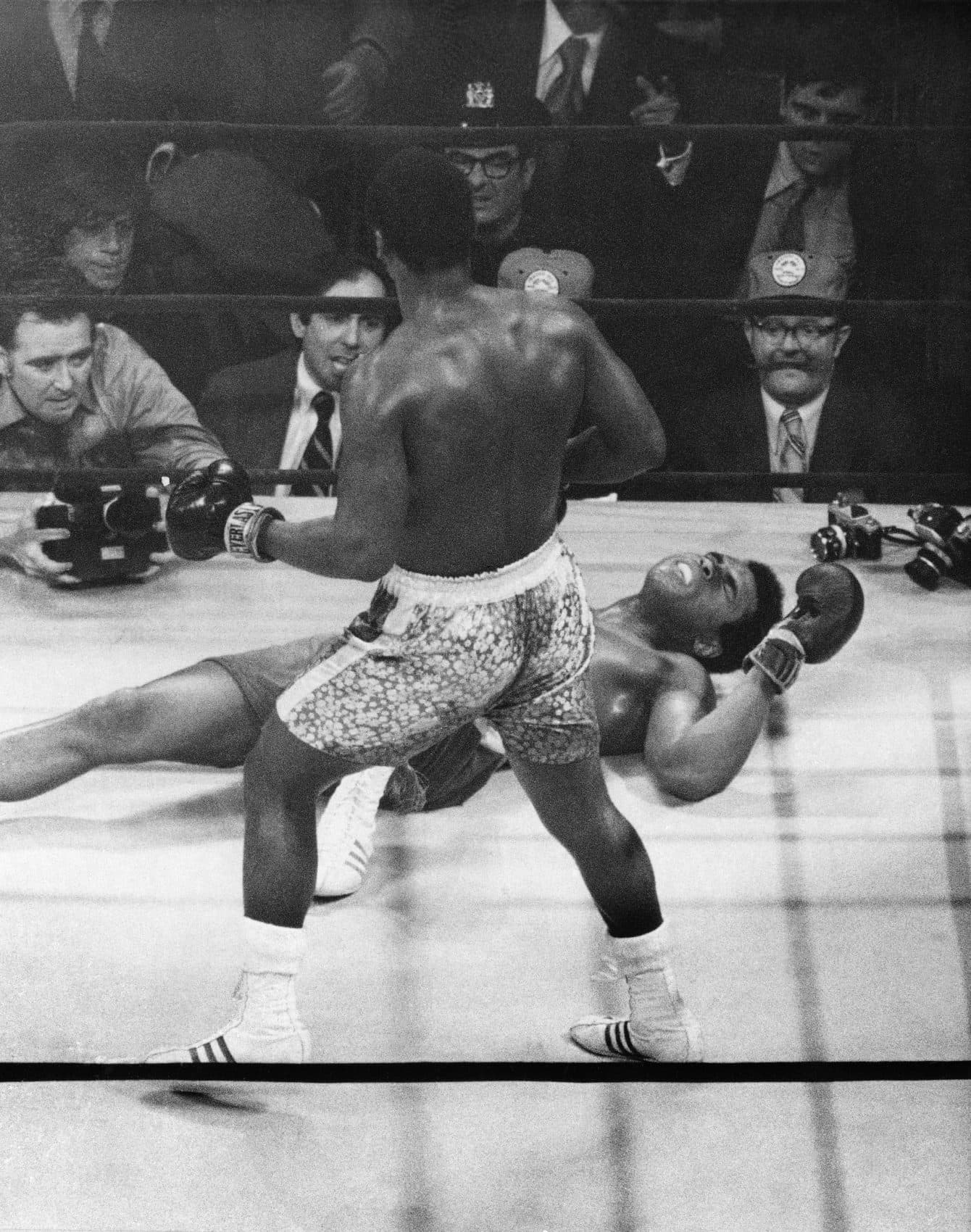 Muhammad Ali lies on the canvas after being knocked down by Joe Frazier in ...