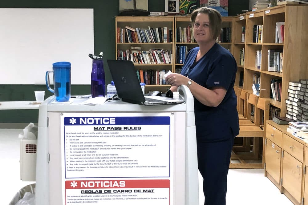 Nurse Jennifer Maillet prepares addiction medications at the Franklin County Jail in Greenfield. (Deborah Becker/WBUR)