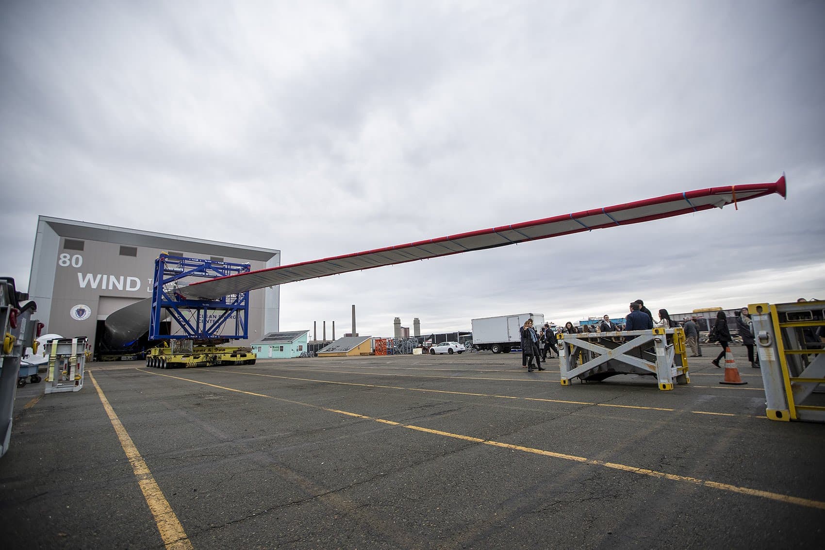The Haliade-X 12MW offshore wind turbine blade protruding out of the Wind Technology Testing Center in Boston. (Jesse Costa/WBUR)