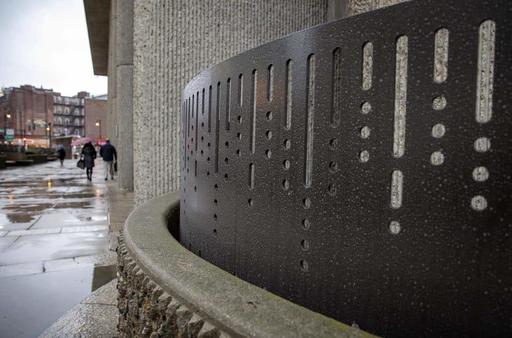 Decorative ironwork surrounding the base of the Hurley Building. (Robin Lubbock/WBUR)