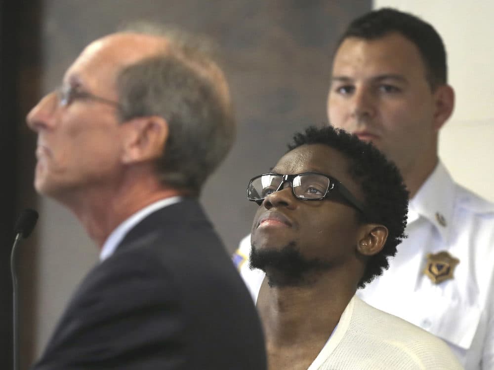 In this July 10, 2017 file photo, Bampumim Teixeira, center, is arraigned in Suffolk Superior Court before Clerk Magistrate Edward Curley in Boston. (Pat Greenhouse/The Boston Globe via AP, Pool, File)