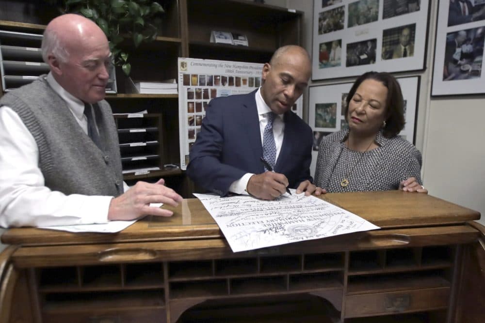 New Democratic presidential candidate and former Massachusetts Gov. Deval Patrick files to have his name listed on the New Hampshire primary ballot Thursday in Concord, N.H. At left is New Hampshire Secretary of State Bill Gardner and at right is Patrick's wife, Diane. (Charles Krupa/AP)