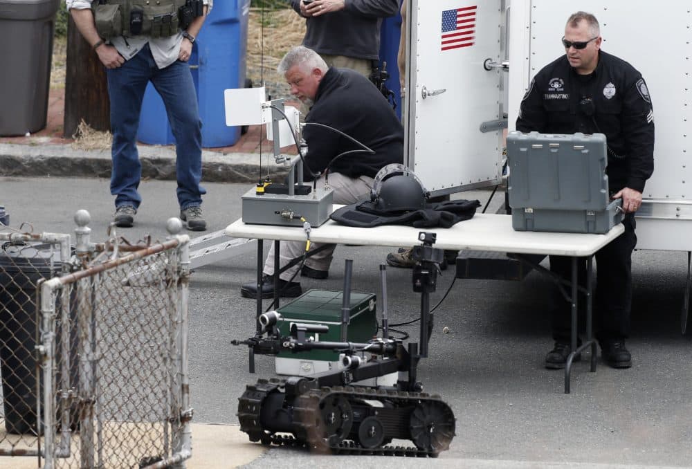 Robots and police departments are no strangers. In this photo, a member of the Cambridge police bomb squad used a robot during a search for the Boston Marathon bombings suspect in 2013. (Michael Dwyer/AP)