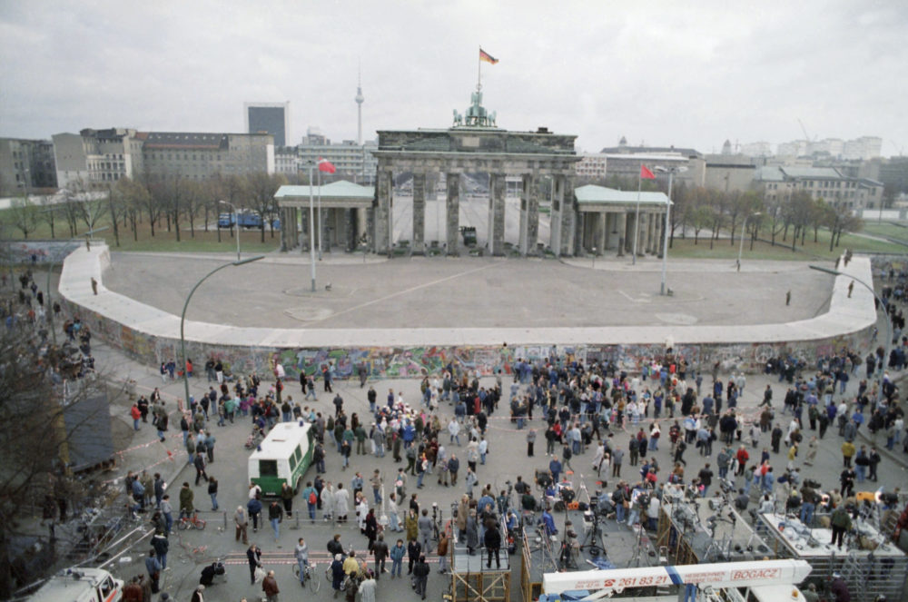 Hundreds of people gather Nov. 15, 1989, at the Berlin Wall in front of the huge Brandenburg Gate in the hopes that East German troops would smash their next passage through the barrier at that highly symbolic point. (Rob Kozloff/AP)