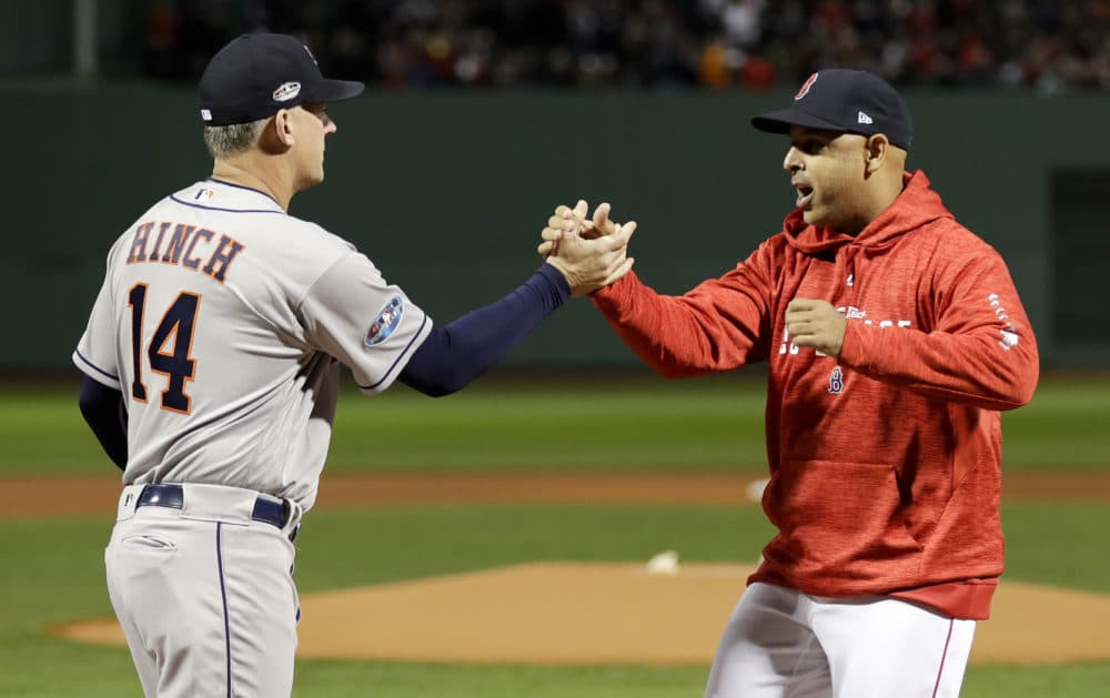 Houston Astros manager AJ Hinch, left, and Boston Red Sox manager Alex Cora shake Hanes before Game 1 of the 2018 American League Championship Series. Both are subjects in MLB's sign stealing investigation. (David J. Phillip/AP)
