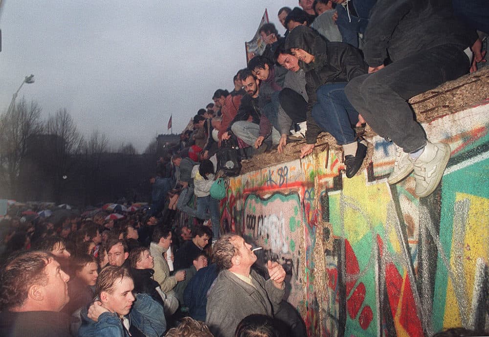 People from East Germany greet citizens of West Germany at the Brandenburg Gate in Berlin 22 December 1989. (Patrick Hertzog/AFP/Getty Images)