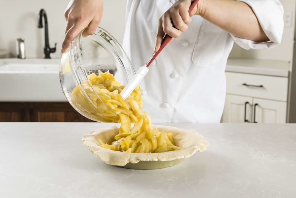 Filling a deep-dish apple pie. (Courtesy America's Test Kitchen)