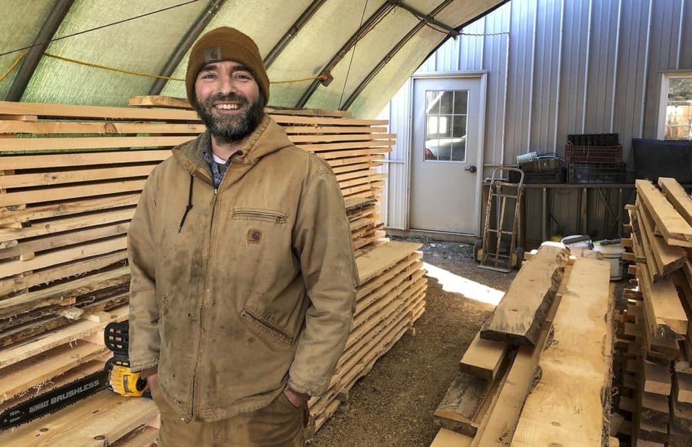 Sage Radachowsky stands near some of his tools in Lenox, Mass.(Fred Thys/WBUR)