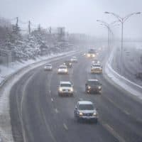 Traffic on the Mass. Pike at rush hour, as snow creates a second slippery commute for Boston drivers. (Robin Lubbock/WBUR)