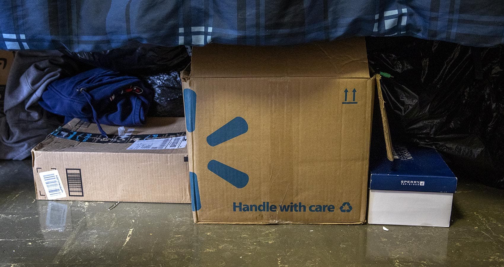 Boxes under Tim Scalona’s bed at UMass. (Robin Lubbock/WBUR)