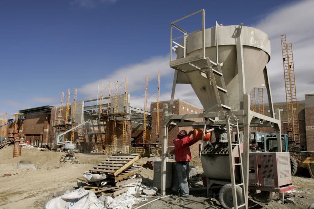 A worker mixes cement at a new shopping complex under construction in Utah. (Douglas C. Pizac/AP)