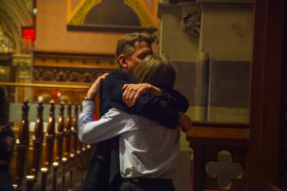 A parents hugs his child after Sunday's concert. (OJ Slaughter for WBUR)