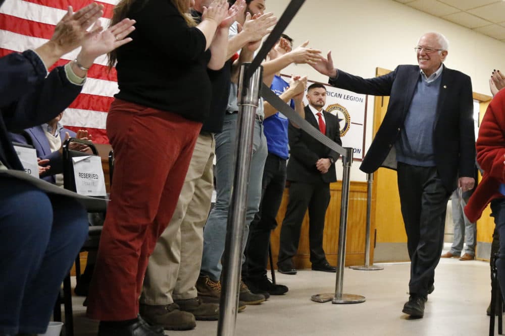 Democratic presidential candidate Sen. Bernie Sanders, I-Vt., high-fives supporters as he arrives at a campaign stop on Nov. 24 in Hillsboro, N.H. (Mary Schwalm/AP)