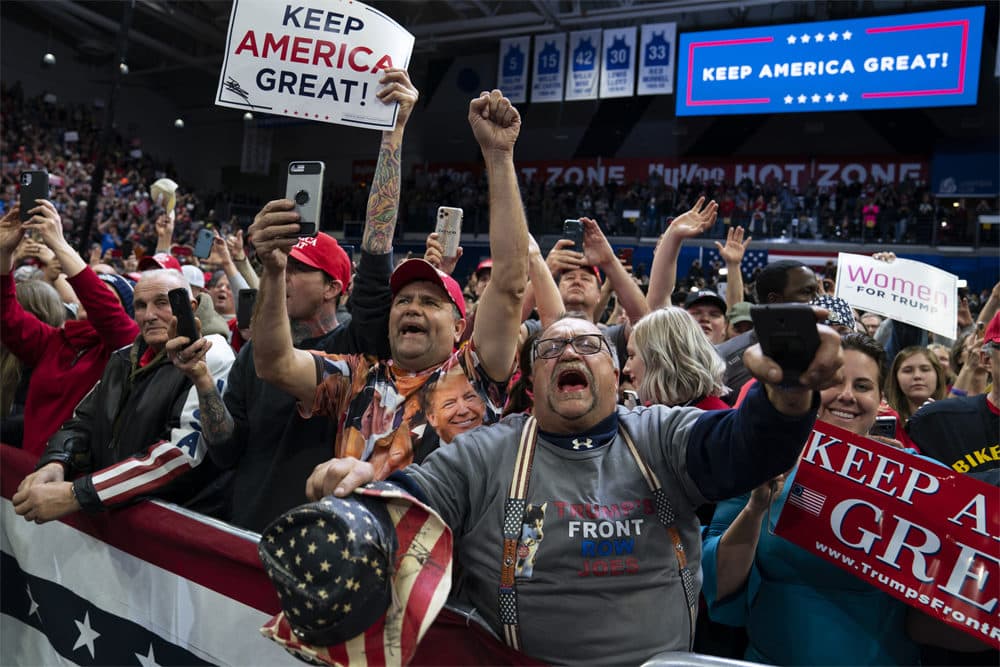 Supporters of President Trump cheer as he arrives to speak at a campaign rally at the Knapp Center Thursday. (Evan Vucci/AP)