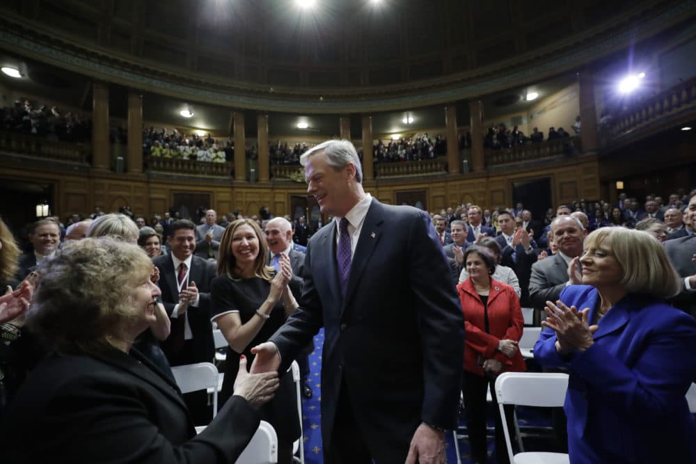 Massachusetts Gov. Charlie Baker, center, enters the House Chamber before he delivers his state of the state address. (Steven Senne/AP)