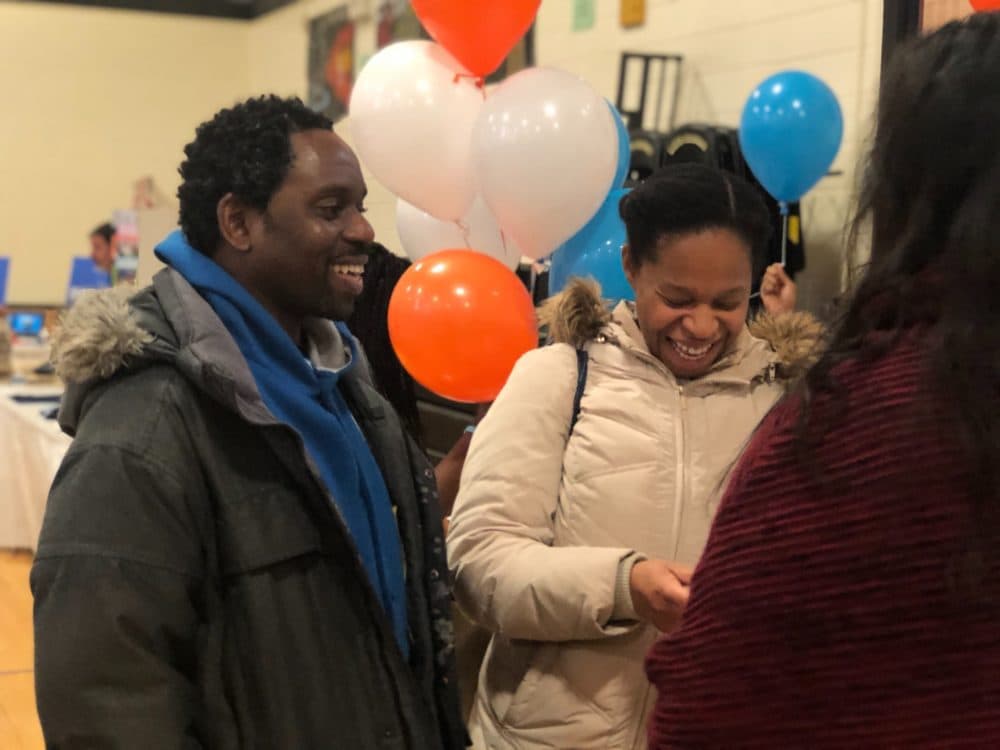Parents Daryl and Natacha Best of Hyde Park at the BPS school showcase in December. (Max Larkin/WBUR)