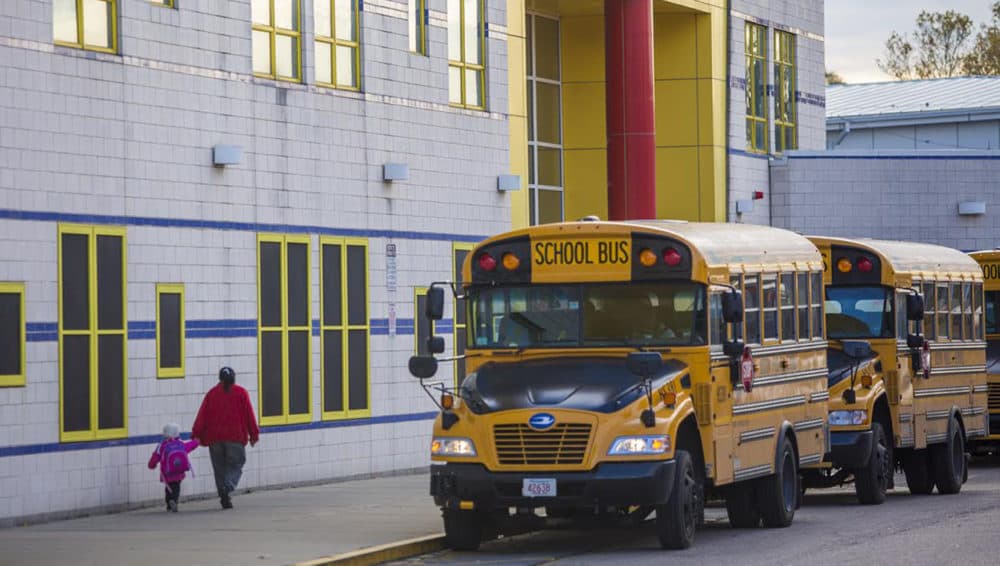 A bus idles outside a Boston school. (Jesse Costa/WBUR)