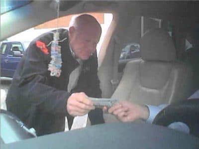 Prosecutors say this October 2018 photo shows former Boston official John Lynch taking a bribe. (Office of the U.S. attorney for Massachusetts)