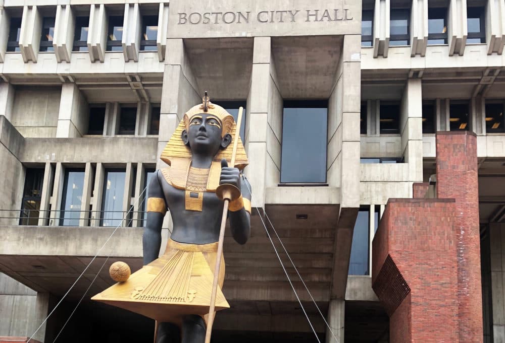 A 25-foot, 2-ton recreation of an Egyptian tomb guard arrived in City Hall Plaza Tuesday. It signaled the summer arrival of a large exhibition of Egyptian artifacts called "King Tut: Treasures of the Golden Pharaoh." (Christian Burno/WBUR)