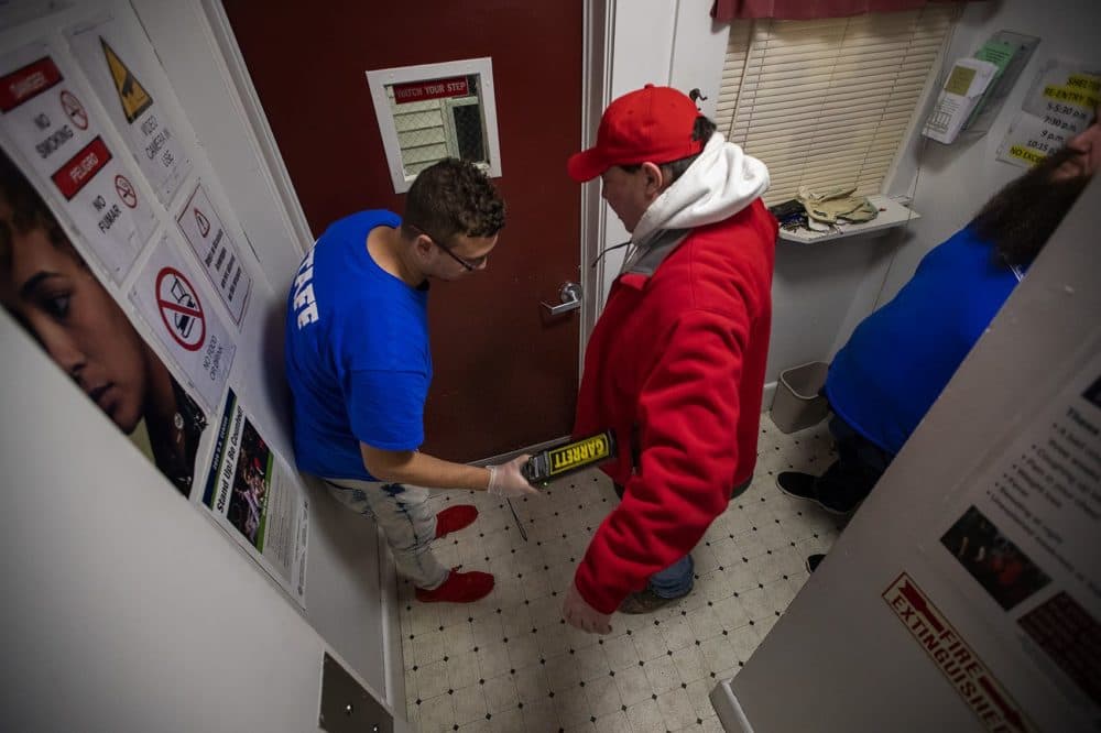 All guests' items are inspected and their bodies are checked using a metal detector before entering Our Father’s House in Fitchburg. (Jesse Costa/WBUR)
