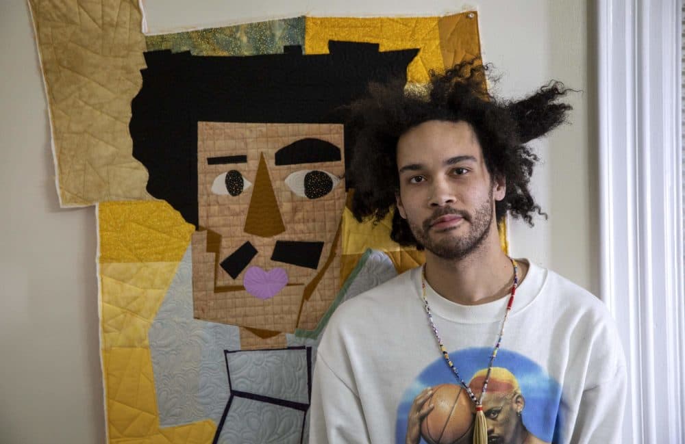 Michael Thorpe in his studio with one of his self-portraits. (Robin Lubbock/WBUR)