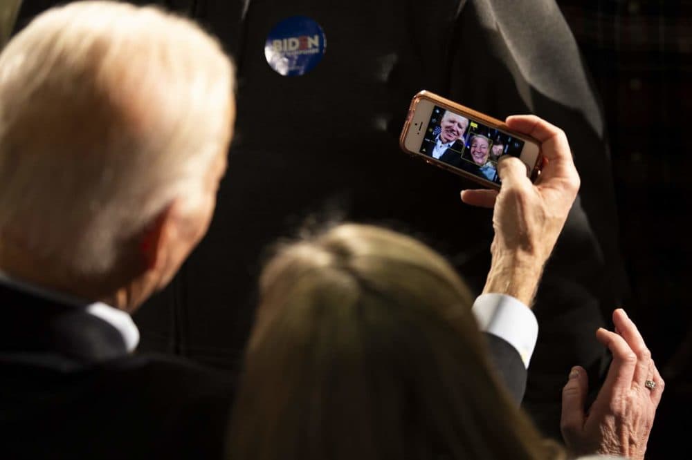 Biden takes a selfie with a supporter at a campaign rally at the Rex Theater in Manchester, NH. (Jesse Costa/WBUR)