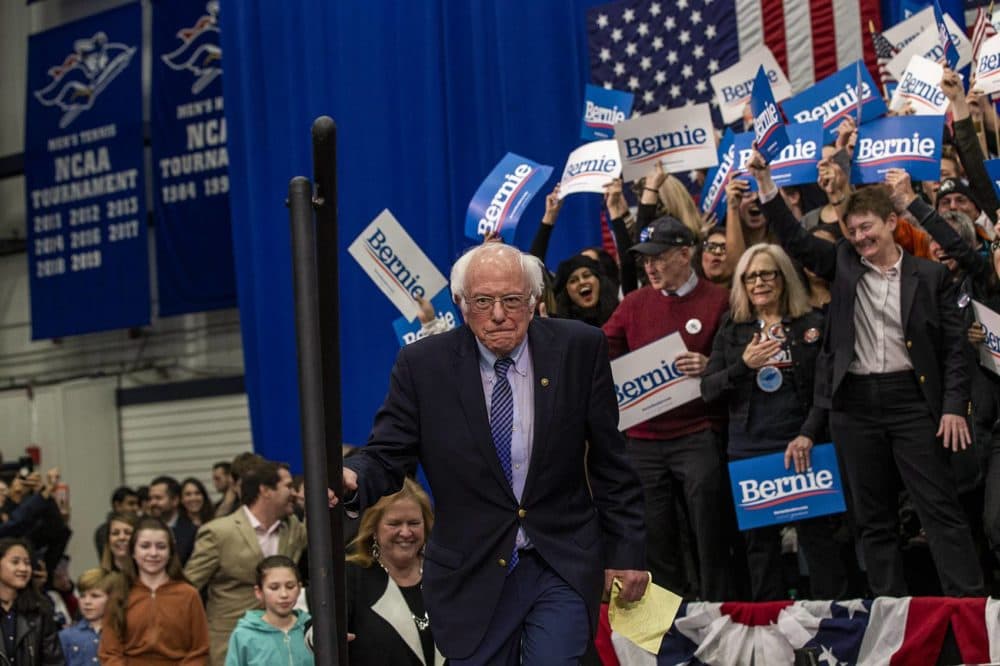 Sanders climbs the steps to the podium to greet supporters after his primary victory in the New Hampshire Primary. (Jesse Costa/WBUR)