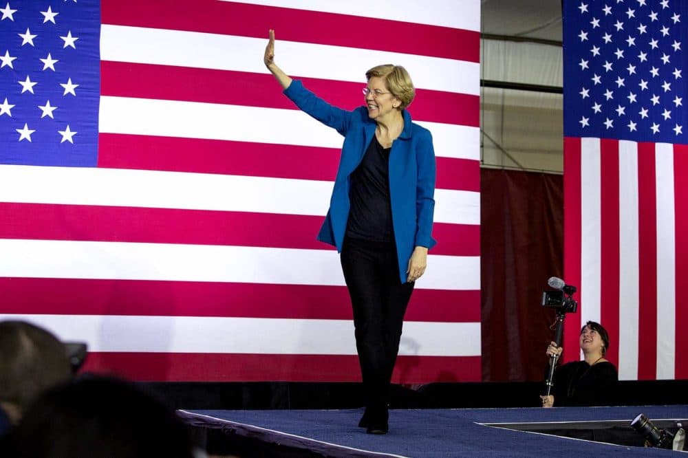 Sen. Elizabeth Warren walks on stage to address a crowd of supporters the night of the New Hampshire primary. (Robin Lubbock/WBUR)