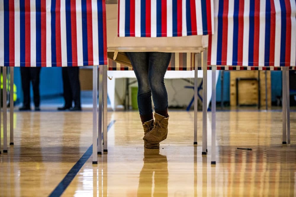 A University of New Hampshire student votes at the polls at Oyster River High School in Durham, N.H., during the first-in-the-nation primary. (Jesse Costa/WBUR)
