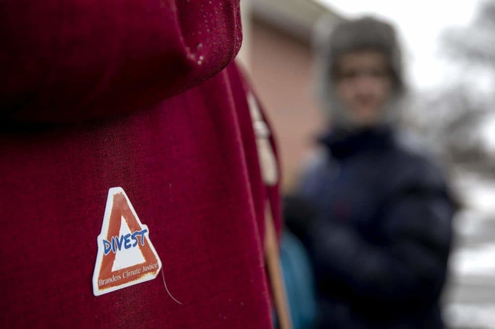 A protester wears a "Divest" sticker during the Brandeis protest. (Robin Lubbock/WBUR)