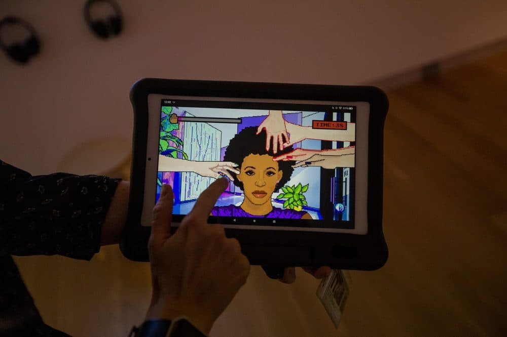Game designer Momo Pixel developed the old-styled pixelated video game called "Hair Nah," about a black woman who is tired people trying to touch her hair while she travels. (Jesse Costa/WBUR)