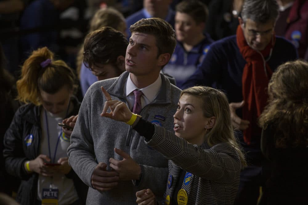 Kyle McLellan, 20, and Ashley Guzik, 21, both of San Diego, California, are volunteers for former South Bend, Indiana, Mayor Pete Buttigieg and watched the early returns roll in for the New Hampshire primary. (Joe Difazio for WBUR)