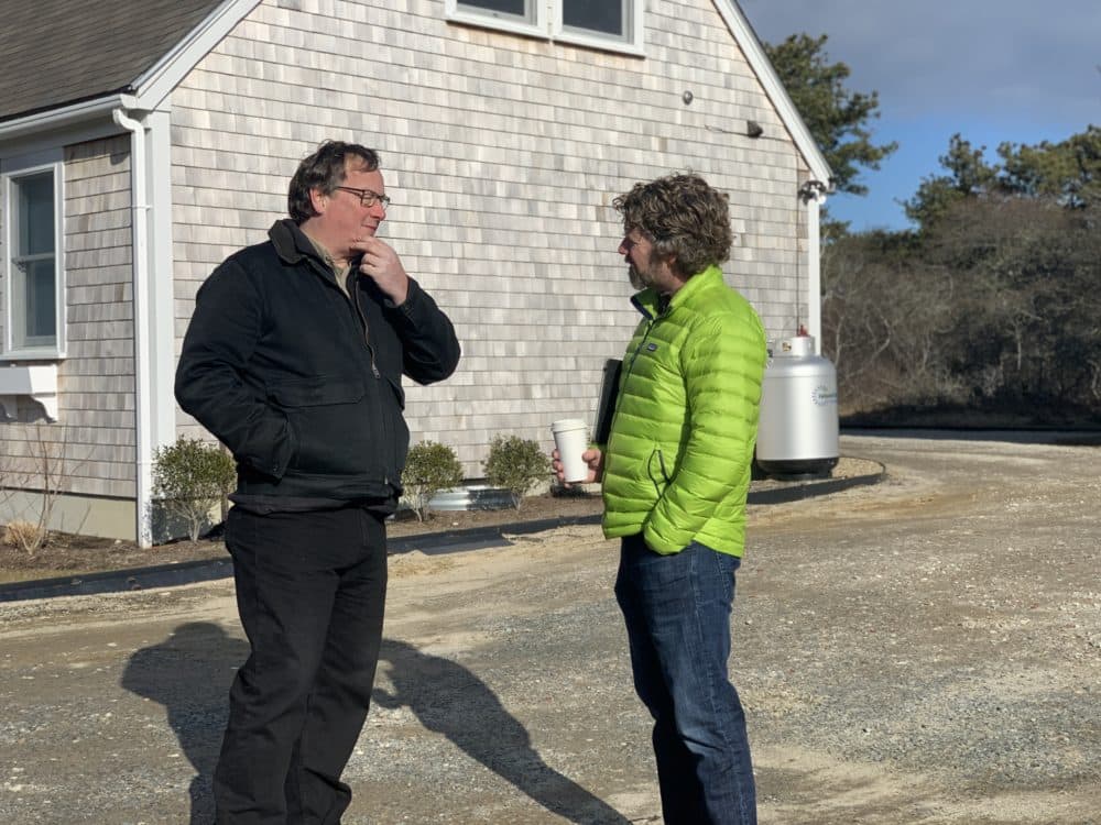 Mark Avery, left, a project manager with the residential construction firm Thirty Acre Wood, catches up with Nantucket's housing chief Tucker Holland. (Simón Rios/WBUR)