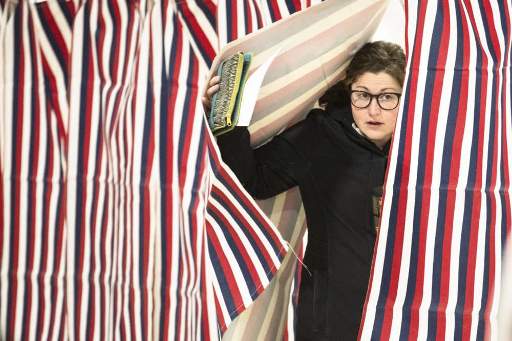 A voter steps out of the booth after casting her ballot in a primary election, Tuesday, Feb. 11, 2020, in Manchester, N.H. (Matt Rourke/AP)