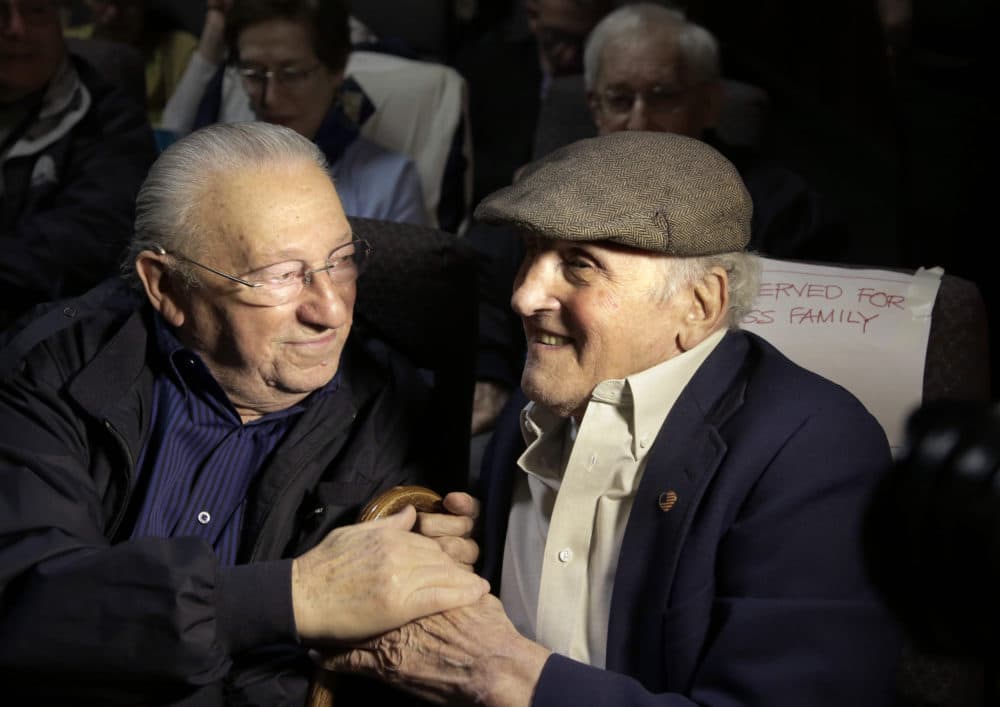 Holocaust survivors Israel Arbeiter, left, and Steve Ross greet one another at a theater before the 2017 premier of the film "Etched in Glass: The Legacy of Steve Ross," in West Newton, Mass. Ross, a Holocaust survivor who spent decades searching for the soldier who helped him at a concentration camp in 1945, died Monday. (Steven Senne/AP File Photo)