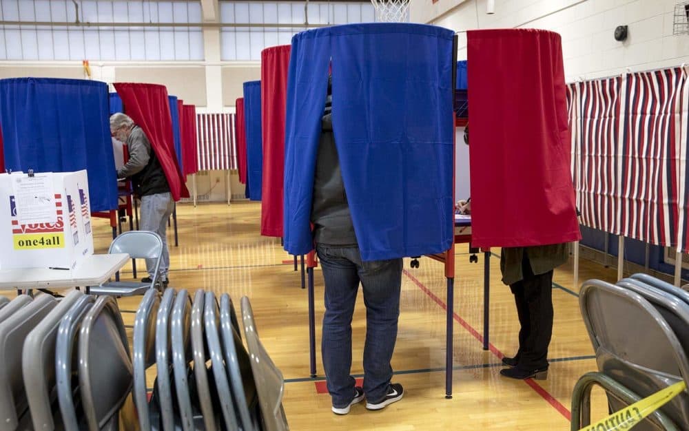 A voters fill in their ballots at Broad Street Elementary School in Nashua, NH. (Robin Lubbock/WBUR)