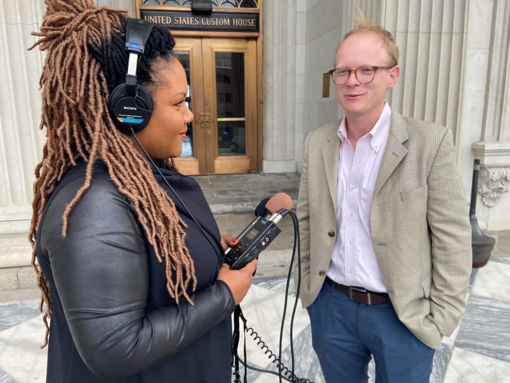 Host Tonya Mosley speaks to Jamie Lovegrove, political reporter for The Post and Courier, outside of the U.S. Custom's House in South Carolina. (Ciku Theuri/Here & Now)