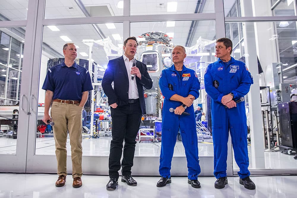 SpaceX founder Elon Musk addresses the media alongside NASA Administrator Jim Bridenstine, and astronauts Doug Hurley and Bob Behnken, during a press conference announcing new developments of the Crew Dragon reusable spacecraft, at SpaceX headquarters in Hawthorne, California on October 10, 2019. (Philip Pacheco / AFP)