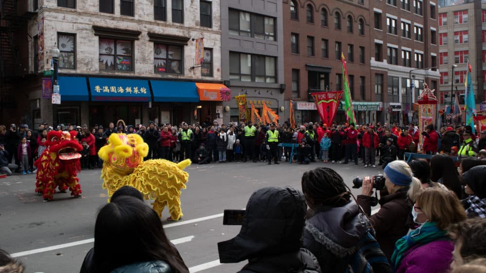At a parade Sunday in Boston's Chinatown celebrating the Lunar New Year, a few onlookers wore face masks. (Adrian Ma/WBUR)
