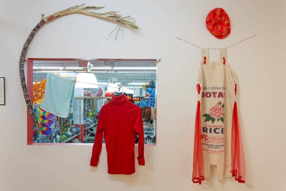Objects from the "Homeward Bound" exhibition, including a rice sack outfit (right) made by Dorothy C.G. Quock of San Francisco’s Chinatown, honoring her father who delivered sacks of rice to customers during the 1930s Great Depression. (Courtesy of Joann Lee)