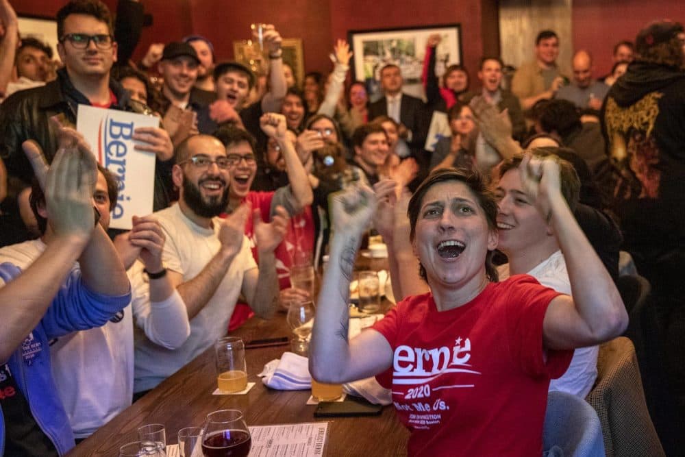 Chelsea Ruscio and the crowd at the Bernie rally at Democracy Brewing in Boston react to campaign gains early in the evening. (Robin Lubbock/WBUR)